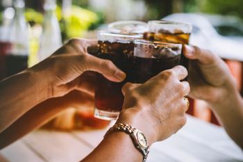 Should You Buy This Thriving Dividend King Stock?: https://g.foolcdn.com/editorial/images/739898/a-group-of-people-toasting-their-soda-filled-glasses.jpg