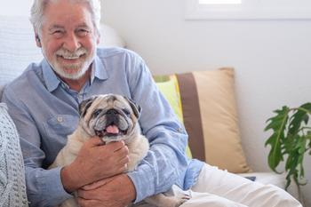 High Net Worth Americans Think They'll Need $3 Million to Retire Comfortably. Here's How to Save That Much On a Modest Salary: https://g.foolcdn.com/editorial/images/737273/smiling-person-holding-dog_gettyimages-1326614891.jpg