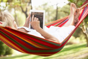 Is a Living Trust the Most Financially Savvy Way to Pass Inheritance to Your Family?: https://g.foolcdn.com/editorial/images/739833/senior-woman-relaxing-in-hammock-reading-ebook.jpg