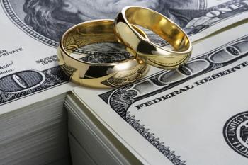 5 Financial Conversations to Have With Your Fiancé Before You Walk Down the Aisle: https://g.foolcdn.com/editorial/images/739985/wedding-rings-on-money.jpg
