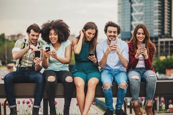2 Remarkable Growth Stocks Set to Surge 60% to 127% According to Wall Street: https://g.foolcdn.com/editorial/images/712798/a-number-of-people-sitting-on-a-bench-and-smiling-while-looking-at-smartphones.jpg