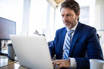 Want to Boost Your Retirement Savings in 2023? Here Are 3 Tips to Make That Happen.: https://g.foolcdn.com/editorial/images/709056/a-person-wearing-a-business-suit-at-a-laptop_gettyimages-1207304964.jpg