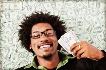 2 Stocks That Cut You a Check Each Month: https://g.foolcdn.com/editorial/images/699280/getty-happy-person-with-cash-money.jpg
