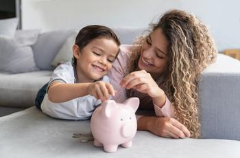 These 2 Financial Stocks Just Raised Their Dividends: https://g.foolcdn.com/editorial/images/773053/adult-and-child-putting-coins-into-a-piggy-bank.jpg