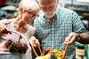 Claiming Social Security Spousal Benefits? Here's What the Average Senior in That Situation Collects Today.: https://g.foolcdn.com/editorial/images/773304/couple-looking-a-flowers-in-basket-retired-1.jpg
