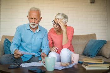 Here's How Much Claiming Social Security at 62 Costs the Average Senior per Month: https://g.foolcdn.com/editorial/images/765164/stressed-couple-looking-at-documents.jpg