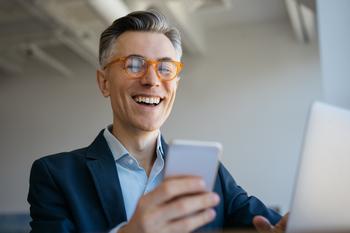 Why Is Nobody Talking About This Crypto Up 227% for the Year?: https://g.foolcdn.com/editorial/images/712852/a-smiling-man-at-a-laptop-holding-a-cell-phone.jpg