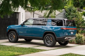 Why EVs and Auto Stocks Are Taking It on the Chin Today: https://g.foolcdn.com/editorial/images/749709/2022-rivian-r1s-driveway.jpg