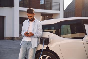 Why Shares of Fisker Are Driving Higher Today: https://g.foolcdn.com/editorial/images/732883/driver-uses-a-smartphone-while-waiting-for-an-ev-to-charge.jpg