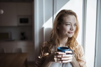3 Reasons You Won't Regret Saving in a Roth IRA: https://g.foolcdn.com/editorial/images/731235/smiling-person-sitting-in-window-holding-coffee-mug.jpg