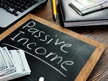1 Top Ultra-High-Yield Stock to Buy for Passive Income in December: https://g.foolcdn.com/editorial/images/711611/a-small-chalk-board-with-passive-income-written-out-in-near-stacks-of-100-bills.jpg