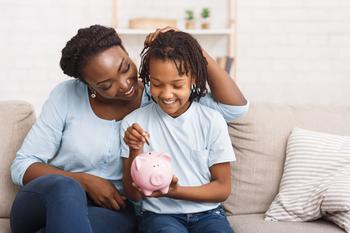 How Much Should I Contribute to My Child's Roth IRA in 2023?: https://g.foolcdn.com/editorial/images/716309/parent-and-child-putting-coins-into-piggy-bank-at-home.jpg