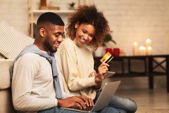 Will Visa or Mastercard Have a Better 2023?: https://g.foolcdn.com/editorial/images/710970/couple-credit-card-online-shopping-happy.jpg