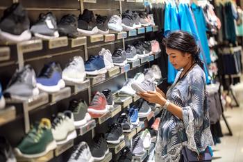 Better Buy: Nike vs. Adidas: https://g.foolcdn.com/editorial/images/714276/woman-shopping-shoe-store.jpg