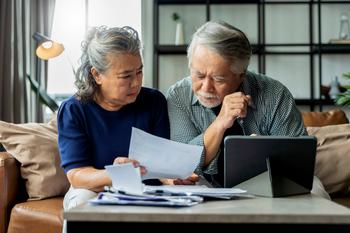 Delaying Social Security Past This Age Will Cost You Money, Guaranteed: https://g.foolcdn.com/editorial/images/684303/serious-couple-looking-at-documents-together.jpg