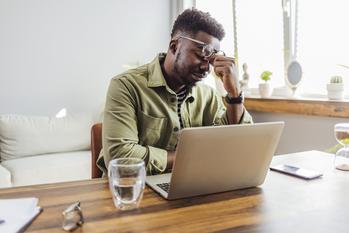 Why Do Student Loans Get So Out of Hand, and How Can I Avoid It?: https://g.foolcdn.com/editorial/images/740167/man-20s-laptop-stressed-gettyimages-1412215765.jpg