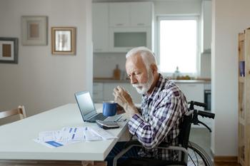 More People Now Say They Can't Ever Retire. Some Steps to Skirt That Fate: https://g.foolcdn.com/editorial/images/746622/man-in-wheelchair-at-desk-with-financial-stuff.jpg