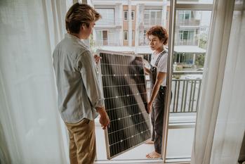 Better Buy: SolarEdge vs. Enphase: https://g.foolcdn.com/editorial/images/748072/installing-solar-panel-on-the-balcony-of-the-house.jpg