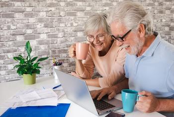 3 Ways to Lower Your Taxes in Retirement: https://g.foolcdn.com/editorial/images/723306/senior-couple-laptop-smiling-gettyimages-1413031117.jpg
