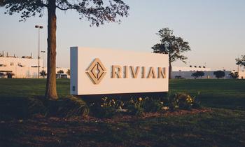 Why Shares of Rivian Are Driving Higher This Week: https://g.foolcdn.com/editorial/images/842578/building-with-rivian-logo-sign-on-front-lawn.jpg
