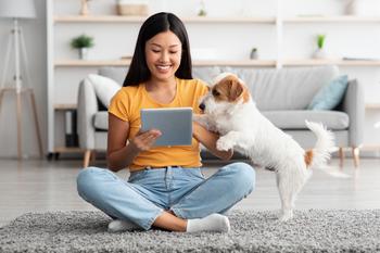2 Roaring Stocks to Hold for the Next 20 Years: https://g.foolcdn.com/editorial/images/738839/using-a-tablet-with-a-dog.jpg