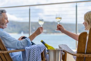 Better Cruise Line Stock: Carnival vs. Royal Caribbean Cruises: https://g.foolcdn.com/editorial/images/767099/couple-enjoys-wine-while-on-a-cruise.jpg