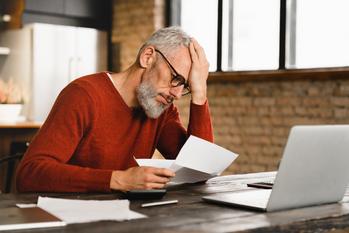 Unhappy With Your Social Security Benefit? Here's How You Can Boost It: https://g.foolcdn.com/editorial/images/694229/older-man-stressed-holding-document-at-laptop_gettyimages-1359033046.jpg