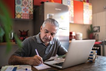 Here's One Great Reason to Delay Your Medicare Enrollment Past Age 65: https://g.foolcdn.com/editorial/images/776068/senior-man-laptop-taking-notes-gettyimages-1278336166.jpg