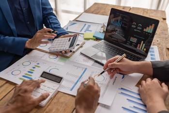 Should You Buy Ares Capital Corporation Stock While It's Below $21?: https://g.foolcdn.com/editorial/images/844700/professionals-sit-at-a-table-and-review-financial-charts-getty.jpg