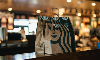 If You Buy Starbucks With $10,000 in 2025, Will You Become a Millionaire in 10 Years?: https://g.foolcdn.com/editorial/images/832295/starbucks_bags_carryout_with_logo_sbux.png
