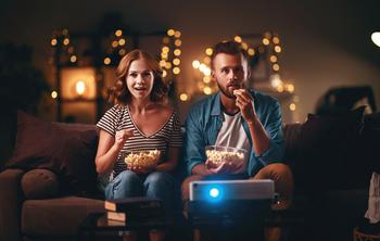 Warner Bros. Discovery: Buy, Sell, or Hold?: https://g.foolcdn.com/editorial/images/731498/couple-watching-television-projector-at-home-popcorn.jpg