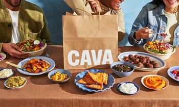 Can Cava Become the Next Chipotle?: https://g.foolcdn.com/editorial/images/767424/people-eating-on-a-table-wit-cava-logo-in-view_cava-1.jpg