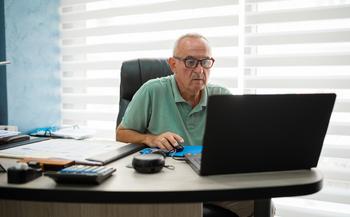 Social Security May Be Cutting Benefits. You Can Compensate by Doing This: https://g.foolcdn.com/editorial/images/733997/older-man-desk-serious-gettyimages-1418582589.jpg