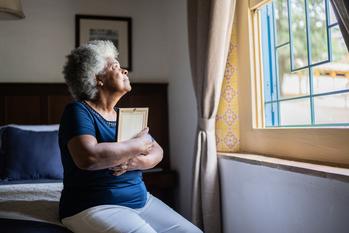 Widows Benefits: What to Do if Your Spouse Collected Social Security Early: https://g.foolcdn.com/editorial/images/736491/mourning-loved-one-holding-picture-frame.jpg
