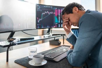Struggling With Crypto Volatility? Do These 3 Things Right Now.: https://g.foolcdn.com/editorial/images/835483/downbeat-investor-in-front-of-screens.jpg