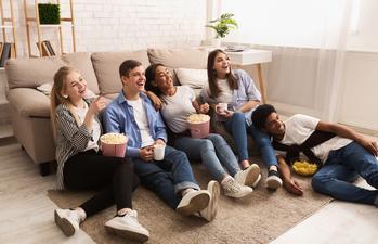 Surprise! Connected TV Is Dominating Global Advertising. That's Great News for The Trade Desk and Roku.: https://g.foolcdn.com/editorial/images/739704/a-group-of-young-friends-sitting-on-the-floor-watching-television.jpg