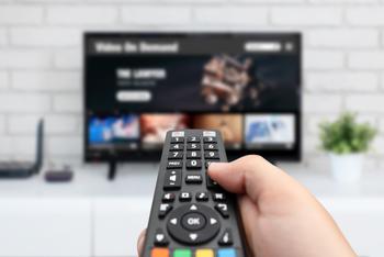 Is Roku Stock a Buy Now?: https://g.foolcdn.com/editorial/images/736307/man-watching-tv-remote-control-in-hand.jpg