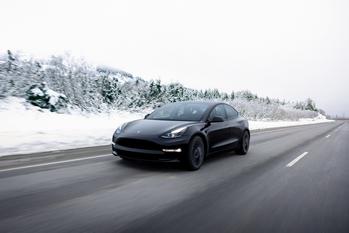 1 Stock-Split Stock Set to Soar 641% From Its 52-Week Low, According to Cathie Wood: https://g.foolcdn.com/editorial/images/698836/a-black-tesla-car-driving-on-an-open-road-in-the-snow.jpg