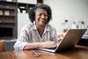 You Might Come Out Ahead Financially by Claiming Social Security at 62: https://g.foolcdn.com/editorial/images/771206/older-woman-laptop-smiling-gettyimages-1304406423.jpg