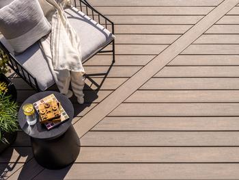 Trex Transcend® Lineage™ Composite Decking Recognized in Good Housekeeping’s 2024 Sustainable Innovation Awards: https://mms.businesswire.com/media/20240312963395/en/2059993/5/trn-lineage-auburn-014-bc-chair-blanket-pillow-table-1280x1280.jpg