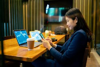3 ETFs That Are All You Need for Retirement: https://g.foolcdn.com/editorial/images/698889/person-looking-at-phone-with-laptops-open-in-front-of-them-on-desk.jpg