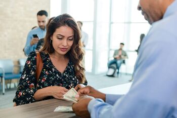 Looking for Safe Income Investments? These 2 ETFs Pay More Than Double the S&P 500 Average.: https://g.foolcdn.com/editorial/images/841673/person-receiving-cash-at-a-financial-institution.jpg