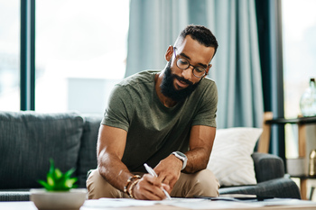 You Aren't Ready to Claim Social Security if You Haven't Done These 3 Things: https://g.foolcdn.com/editorial/images/839975/adult-writing-with-pen-on-table-and-sofa.jpg