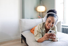 Why TJX Companies Stock Floated Higher Today: https://g.foolcdn.com/editorial/images/843653/happy-person-using-headphones-and-a-phone-while-lying-on-a-couch.jpg