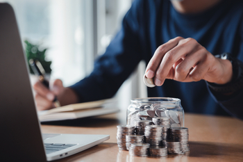 Don't Give Up on Dividend Stocks. 5 Dividend Kings Down Between 5% and 33% to Buy in November: https://g.foolcdn.com/editorial/images/842629/an-investor-sits-in-front-of-a-laptop-computer-and-places-a-coin-in-a-glass-jar-next-to-other-stacks-of-coins-illustrating-the-concept-of-building-a-growing-passive-income-stream-from-dividend-stocks.jpg
