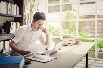 3 Top ETFs I Can't Wait to Buy More of in My Retirement Account This November: https://g.foolcdn.com/editorial/images/842291/investor-considers-papers-while-sitting-near-books.jpg