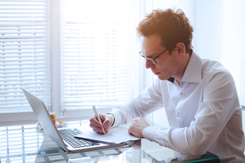 3 Top REIT Dividend Stocks to Buy Right Now With $1,000 for Passive Income: https://g.foolcdn.com/editorial/images/829093/man-reading-paper-report-statement-and-using-laptop.jpg