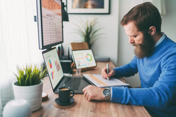 Should You Choose a Roth IRA Over a 401(k) for Retirement Savings?: https://g.foolcdn.com/editorial/images/845537/bearded-person-at-desk-by-computer-taking-notes.jpg