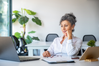 Retiring in 2026? Here's How Much Cash You Should Have on Hand.: https://g.foolcdn.com/editorial/images/845796/older-woman-in-office-working-office.jpg