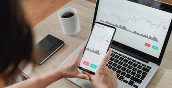 Bitcoin vs. Dogecoin: What's the Better Long-Term Play?: https://g.foolcdn.com/editorial/images/847528/trader-app-on-phone-and-laptop.jpg